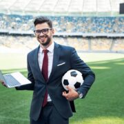 Smiling,Young,Businessman,In,Suit,With,Laptop,And,Soccer,Ball